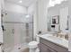 This bathroom has a shower with glass enclosure, gray vanity and neutral walls at 17910 Waterville Pl, Lakewood Ranch, FL 34202