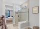 Bathroom featuring glass enclosed shower with built-in bench and views of the main bedroom at 17910 Waterville Pl, Lakewood Ranch, FL 34202
