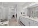 This is a bright bathroom with a glass enclosed shower and dual sink vanity with white cabinets at 17910 Waterville Pl, Lakewood Ranch, FL 34202
