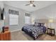 This secondary bedroom has great light, a ceiling fan, side tables, and is carpeted at 17910 Waterville Pl, Lakewood Ranch, FL 34202