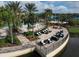 Aerial view of outdoor community space with stylish seating, pools, palms and meticulous landscaping at 17910 Waterville Pl, Lakewood Ranch, FL 34202