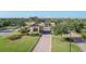 Beautiful community entrance with a brick-paved driveway, lush greenery, and a well-maintained gatehouse at 17910 Waterville Pl, Lakewood Ranch, FL 34202