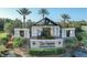 Del Webb Lakewood Ranch entrance featuring a elegant sign, lush landscaping, and views of a serene lake at 17910 Waterville Pl, Lakewood Ranch, FL 34202