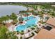 Community pool featuring beach entry, volleyball net, palm trees, and comfortable lounge seating at 17910 Waterville Pl, Lakewood Ranch, FL 34202