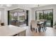Dining area with a table for six and sliding doors leading to the screened lanai at 17910 Waterville Pl, Lakewood Ranch, FL 34202