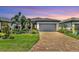 Charming one-story home with a brick driveway and lush, mature landscaping at 17910 Waterville Pl, Lakewood Ranch, FL 34202