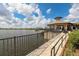 Stunning lake view showcasing the outdoor patio, lush landscaping, and tranquil waterfront setting at 17910 Waterville Pl, Lakewood Ranch, FL 34202