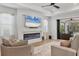 Modern living room featuring a fireplace, media center, and sliding glass doors at 17910 Waterville Pl, Lakewood Ranch, FL 34202