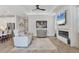 Bright living area with a linear fireplace and a large TV at 17910 Waterville Pl, Lakewood Ranch, FL 34202