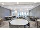 A community meeting room with round tables, seating for many, recessed lighting, and neutral walls at 17910 Waterville Pl, Lakewood Ranch, FL 34202