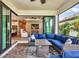 Covered outdoor living space with ceiling fan, pavers, ample seating, and views to the interior at 17910 Waterville Pl, Lakewood Ranch, FL 34202