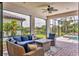 Covered outdoor living space with ceiling fan, pavers, ample seating, and views of the pool at 17910 Waterville Pl, Lakewood Ranch, FL 34202