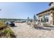 Picturesque outdoor patio with lake views, stylish furniture, and a cozy fire pit area at 17910 Waterville Pl, Lakewood Ranch, FL 34202