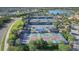 Aerial view of community pickleball and tennis courts with lush landscaping and lake views at 17910 Waterville Pl, Lakewood Ranch, FL 34202