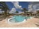 Inviting community pool with sun loungers, palm trees, blue skies, and clubhouse at 17910 Waterville Pl, Lakewood Ranch, FL 34202