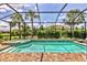 Screened-in pool with a tanning ledge, lush landscaping, and ample space for outdoor entertaining at 17910 Waterville Pl, Lakewood Ranch, FL 34202