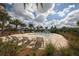 Relaxing community pool area with lounge chairs, a small pool, and lush landscaping at 17910 Waterville Pl, Lakewood Ranch, FL 34202