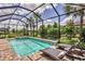 The sparkling pool is surrounded by lush landscaping and has plenty of room for lounge chairs at 17910 Waterville Pl, Lakewood Ranch, FL 34202