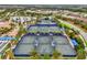 Aerial view of tennis courts with well-maintained surfaces and landscaping near community homes at 17910 Waterville Pl, Lakewood Ranch, FL 34202