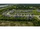 Community aerial view with several rows of single Gathering homes and lots of green space at 2136 Midnight Pearl Dr, Sarasota, FL 34240