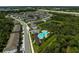 Aerial view of community amenities, including a sparkling pool, pool house, and common parking area at 2136 Midnight Pearl Dr, Sarasota, FL 34240
