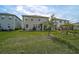 Grassy backyard featuring a swing set and seating area, a wonderful space for outdoor activities and Gathering gatherings at 2136 Midnight Pearl Dr, Sarasota, FL 34240