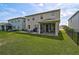Backyard features a covered patio, fenced yard, and outdoor seating area, ideal for entertaining at 2136 Midnight Pearl Dr, Sarasota, FL 34240