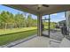 Spacious screened patio with backyard view, including a swing set, perfect for Gathering outdoor enjoyment at 2136 Midnight Pearl Dr, Sarasota, FL 34240
