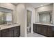 Bathroom featuring a double vanity with dark wood cabinets, granite countertops and tile flooring at 2136 Midnight Pearl Dr, Sarasota, FL 34240