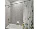 Bathroom featuring tile walls, a bathtub, shower with floral curtain and chrome fixtures at 2136 Midnight Pearl Dr, Sarasota, FL 34240