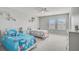 Bright bedroom featuring two twin beds, a ceiling fan, and light gray carpet at 2136 Midnight Pearl Dr, Sarasota, FL 34240