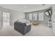 Second floor bonus room with plush carpeting, natural lighting, a TV, and closet for storage at 2136 Midnight Pearl Dr, Sarasota, FL 34240