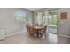 Cozy dining room with a wooden table, chairs and large glass doors leading to the backyard at 2136 Midnight Pearl Dr, Sarasota, FL 34240