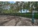 Community dog park with fenced area, mature trees and pet waste station at 2136 Midnight Pearl Dr, Sarasota, FL 34240