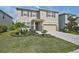 Charming two-story home with a manicured lawn, stone accents, and an attached two-car garage at 2136 Midnight Pearl Dr, Sarasota, FL 34240