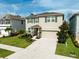 Charming two-story home with stone accents, a well-manicured lawn, and a spacious two-car garage at 2136 Midnight Pearl Dr, Sarasota, FL 34240