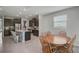 Modern kitchen with stainless steel appliances, granite counters, dark cabinets, an island, and a dining area at 2136 Midnight Pearl Dr, Sarasota, FL 34240