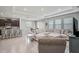Open concept living room and kitchen area with tile flooring, recessed lighting, and barstool seating at 2136 Midnight Pearl Dr, Sarasota, FL 34240