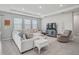 Bright living room with recessed lighting, tile floors, and a large sectional sofa for comfortable seating at 2136 Midnight Pearl Dr, Sarasota, FL 34240
