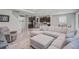 Open-concept living space with tile floors, a large sectional sofa, and a view into the adjacent kitchen at 2136 Midnight Pearl Dr, Sarasota, FL 34240