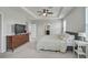 Spacious main bedroom with a tray ceiling, a TV, and lots of natural light at 2136 Midnight Pearl Dr, Sarasota, FL 34240