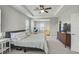 Spacious main bedroom with a tray ceiling, workspace, and lots of natural light at 2136 Midnight Pearl Dr, Sarasota, FL 34240
