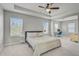 Spacious main bedroom with a tray ceiling, work space, and lots of natural light at 2136 Midnight Pearl Dr, Sarasota, FL 34240