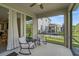 Covered patio area with ceiling fan, perfect for relaxation, features an outside view and comfortable seating at 2136 Midnight Pearl Dr, Sarasota, FL 34240
