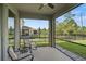 The screened lanai with seating offers views of the fenced backyard and a cozy outdoor area at 2136 Midnight Pearl Dr, Sarasota, FL 34240