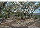 Community playground with slides and climbing structures surrounded by mature shade trees at 2136 Midnight Pearl Dr, Sarasota, FL 34240