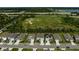 A neat row of homes is seen across the street with a green field beyond at 2136 Midnight Pearl Dr, Sarasota, FL 34240