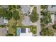 An overhead view shows the home with a solar panel array, in-ground pool, mature trees, and a well-maintained lawn at 2275 Clematis St, Sarasota, FL 34239
