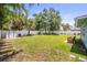 Large fenced backyard with mature trees, and a storage shed at 2275 Clematis St, Sarasota, FL 34239