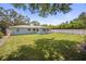 Picture of a large green backyard, partial fence, and view of the exterior of the property for leisure and play at 2275 Clematis St, Sarasota, FL 34239